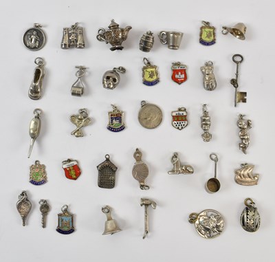 Lot 984 - A group of hallmarked silver bracelet charms...