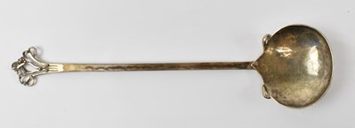 Lot 841 - A white metal spoon with hammered decoration,...