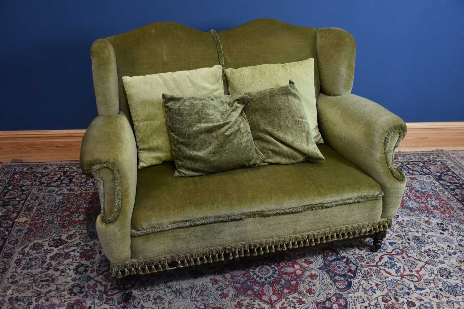 Lot 18 - An early 20th century wingback two seater sofa,...