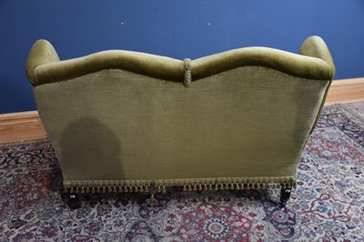 Lot 18 - An early 20th century wingback two seater sofa,...