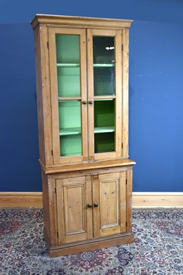 Lot 157 - A pine bookcase, with two glazed doors above...