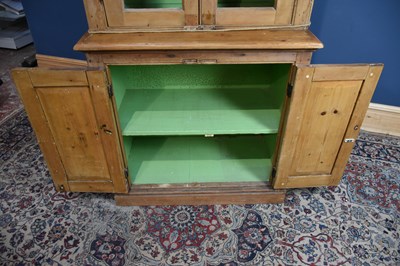 Lot 157 - A pine bookcase, with two glazed doors above...