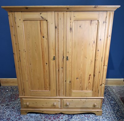 Lot 168 - A modern pine two door wardrobe, with two...