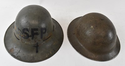 Lot 384 - Two military helmets, one green painted and...