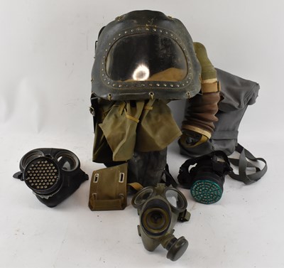 Lot 371 - A group of three WWII gas masks and a baby's...