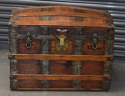 Lot 46 - A brass bound domed top trunk with lift-up...