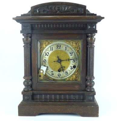 Lot 66 - An early 20th century oak cased chiming mantel clock