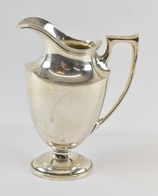 Lot 762 - A sterling silver cream jug, height 13cm,...