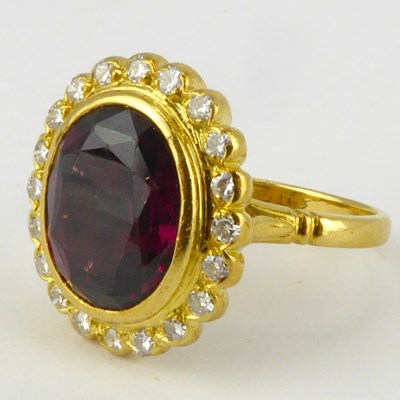 Lot 891 - An 18ct gold diamond and garnet ring, the...