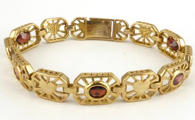 Lot 892 - A 9ct gold bracelet with eleven open oval...