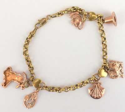 Lot 904 - A 9ct rose gold dainty charm bracelet with six...