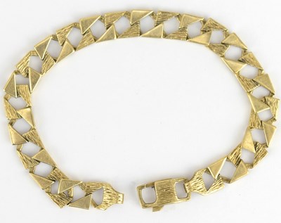 Lot 903 - A vintage 1970s 9ct gold textured curb link...