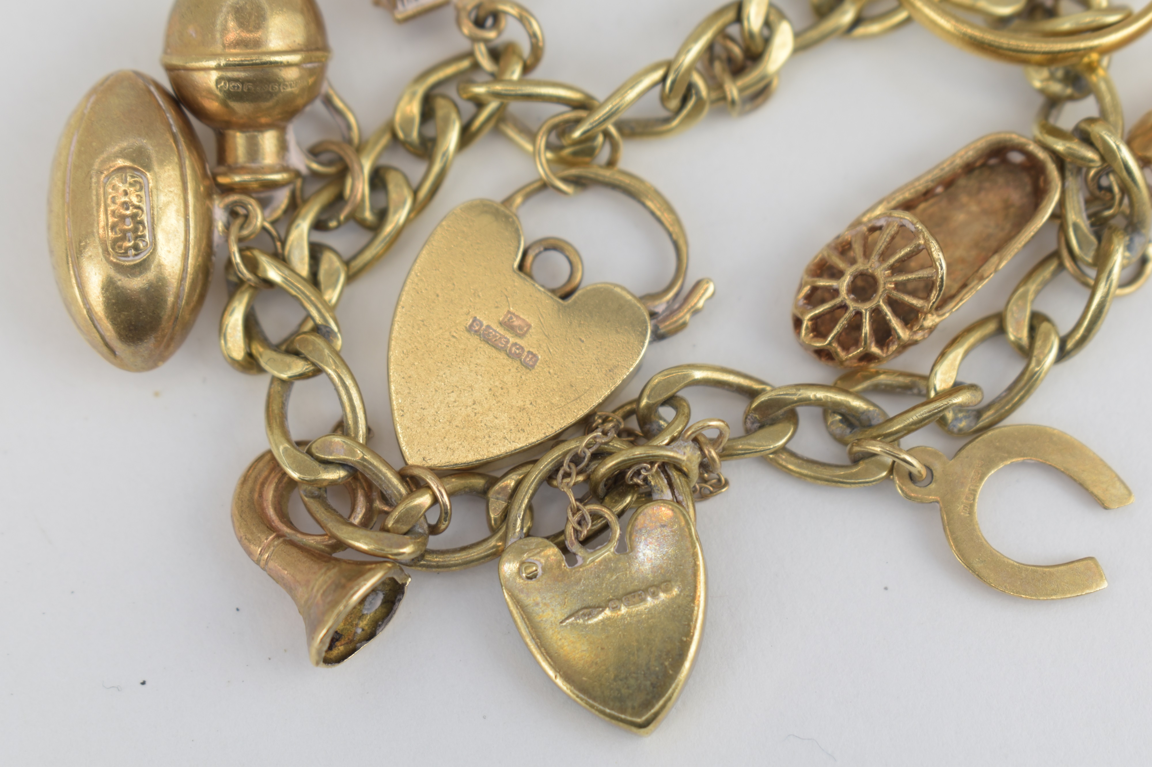 Lot 890 A 9ct Gold Charm Bracelet With Nine Charms