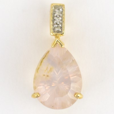 Lot 969 - A 9K rose quartz and diamond yellow gold...