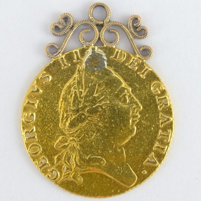 Lot 889 - A 1787 George II gold guinea with yellow metal...