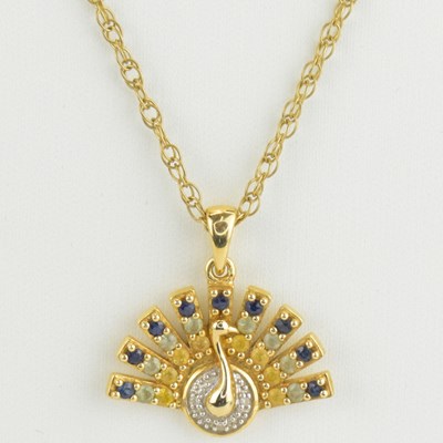 Lot 907 - A diamond and gem set peacock pendant in 14ct...