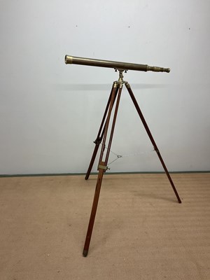 Lot 42 - A reproduction brass telescope on tripod stand,...