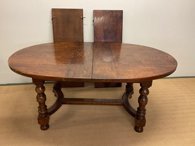 Lot 623 - An oak dining table with two leaves, height...