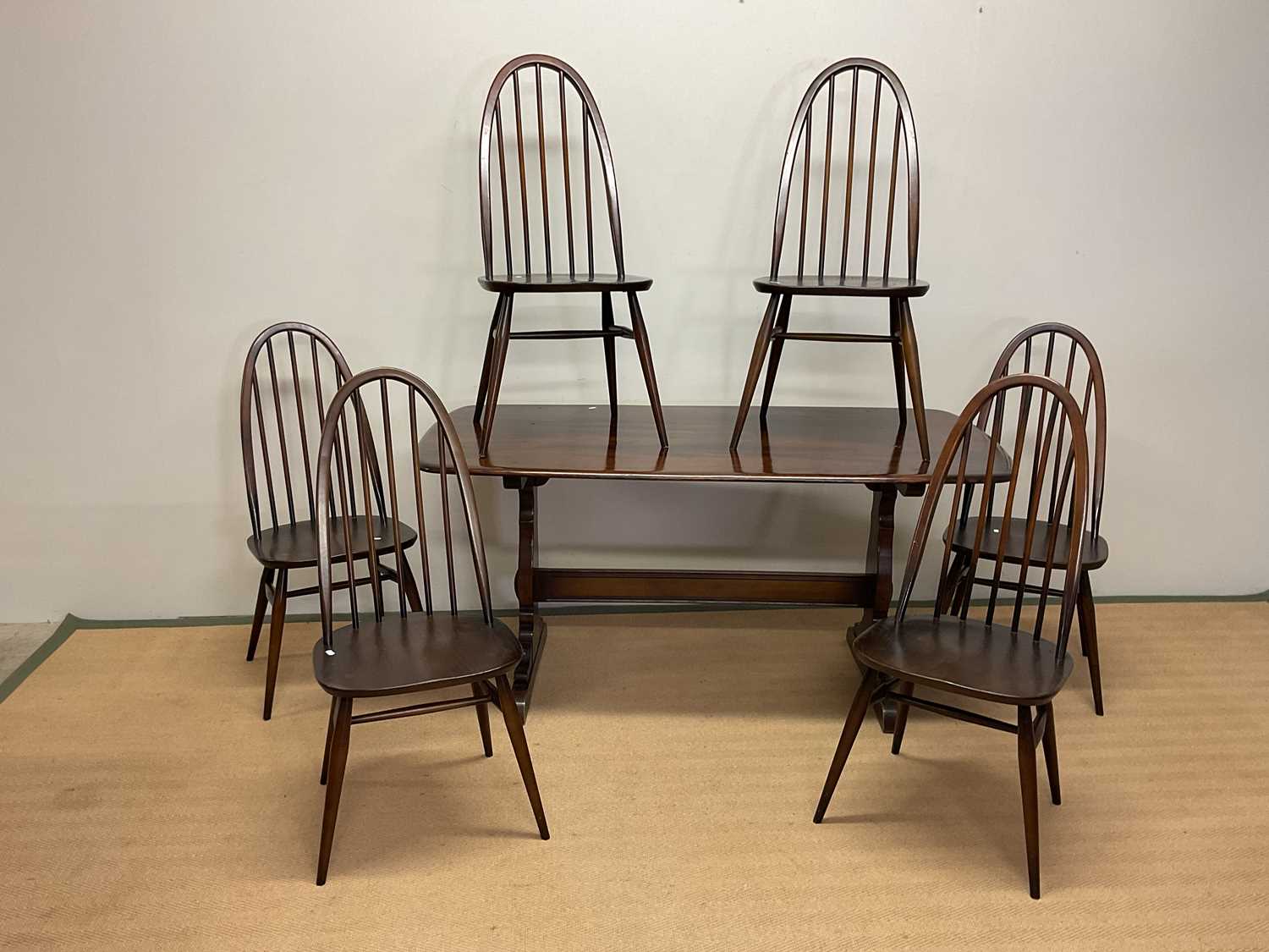 Lot 474 - ERCOL; a dining table and six dining chairs,...