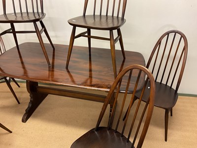 Lot 474 - ERCOL; a dining table and six dining chairs,...