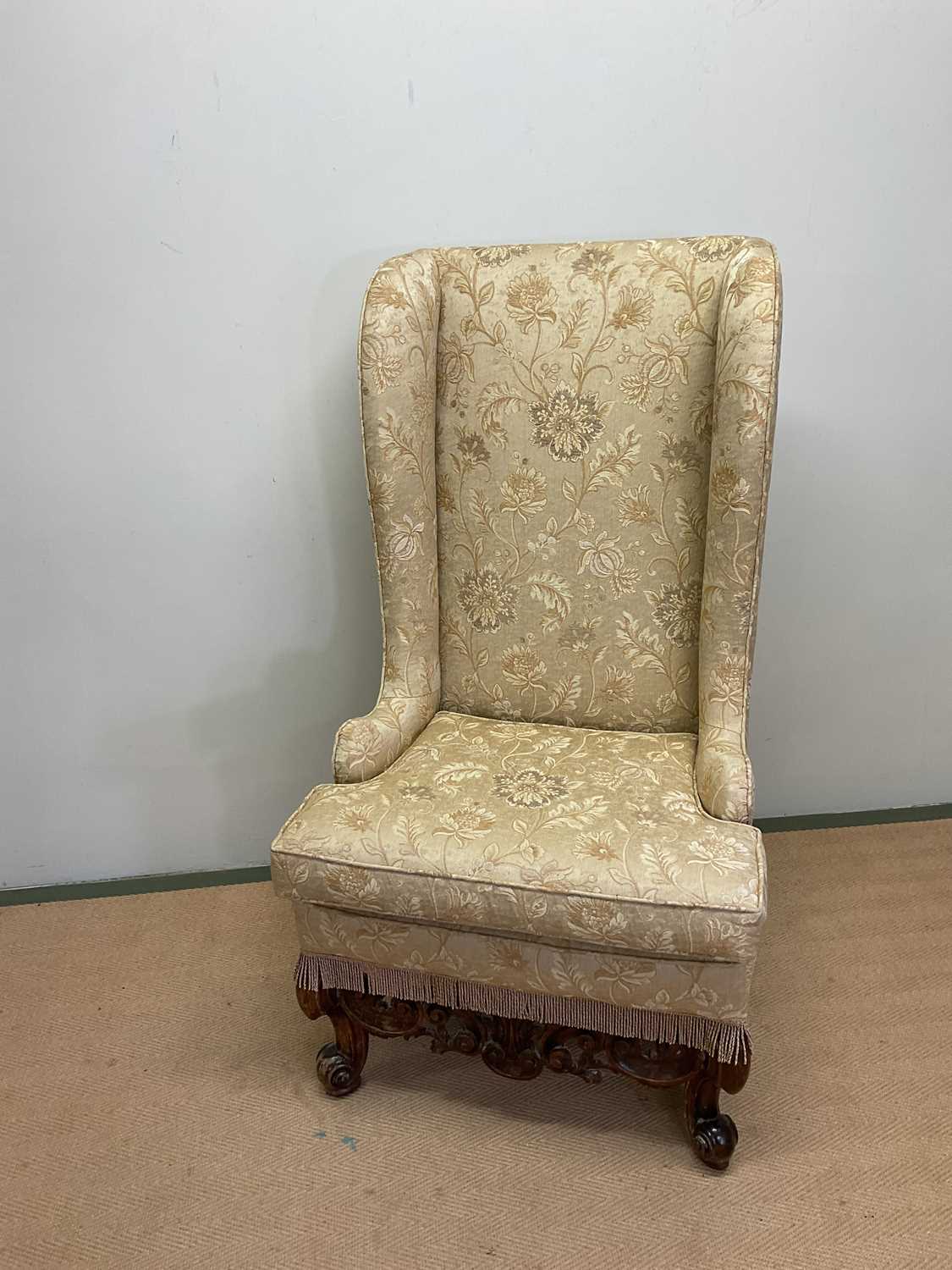 Lot 512 A high wingback chair, height 132cm.