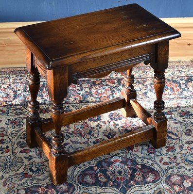 Lot 143 - A reproduction oak joint stool on block legs.