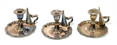 Lot 248 - Three Sheffield plate chambersticks with...