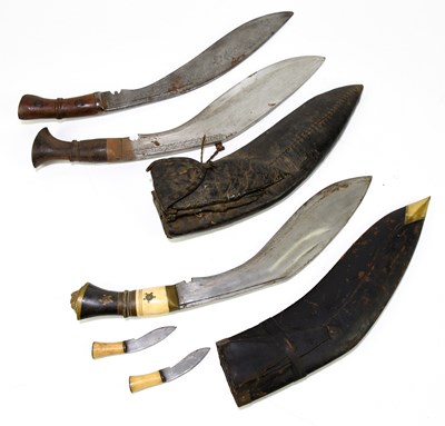 Lot 457 - Three Kukri knives, two examples with scabbard...