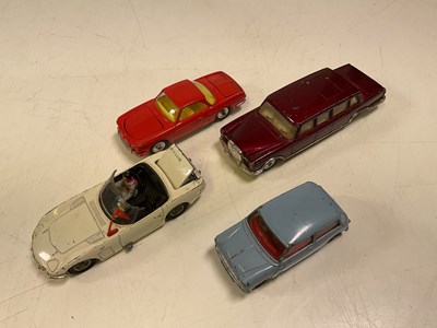 Lot 64 - CORGI; four toy cars including a Morris Mini...