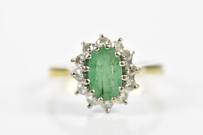 Lot 178 - An 18ct yellow gold emerald and diamond oval...