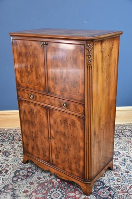 Lot 106 - RACKSTRAW; a modern yew wood cocktail cabinet,...