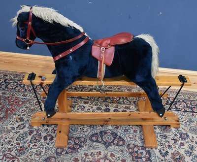 Lot 414 - PEGASUS; a modern rocking horse on pine base,...