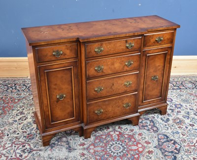 Lot 205 - A reproduction walnut breakfront sideboard of...