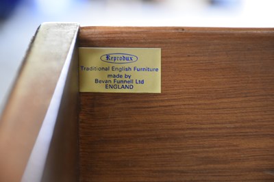 Lot 205 - A reproduction walnut breakfront sideboard of...