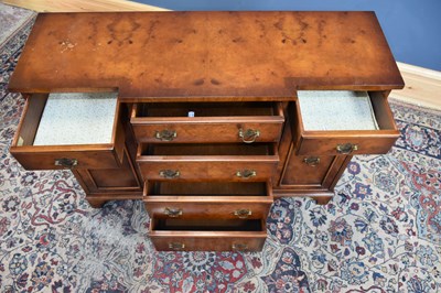 Lot 205 - A reproduction walnut breakfront sideboard of...