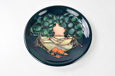 Lot 1302 - MOORCROFT; a modern plate decorated with a...