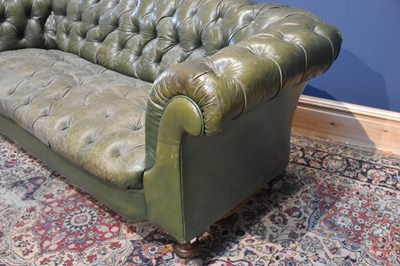 Lot 16 - A Victorian green leather Chesterfield sofa,...