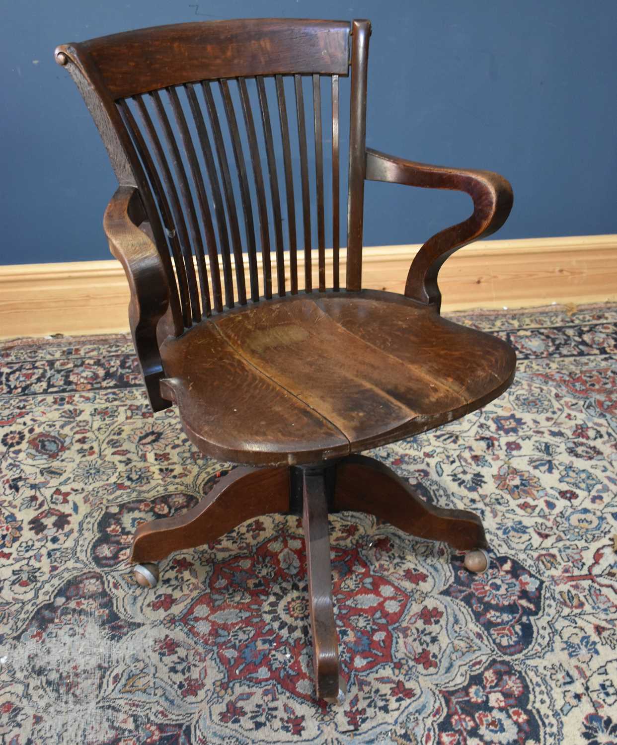 Lot 75 - A 1920s oak office chair with splat back.