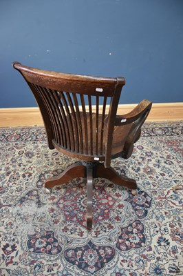 Lot 75 - A 1920s oak office chair with splat back.