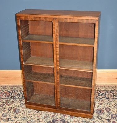 Lot 97 - An early 20th century walnut bookcase, with a...