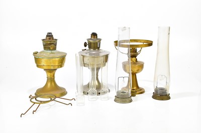 Lot 388 - Three oils lamps including brass examples,...