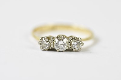 Lot 121 - An 18ct yellow gold and graduated three stone...