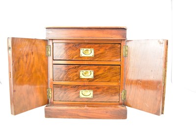Lot 21 - A mahogany table-top chest of three drawers...