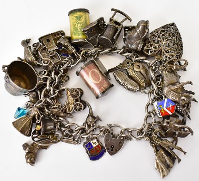 Lot 814 - A silver charm bracelet with approximately...