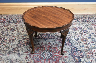 Lot 54 - A 1920s mahogany coffee table with pie crust...