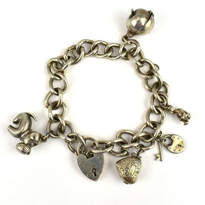 Lot 813 - A hallmarked silver charm bracelet with five...