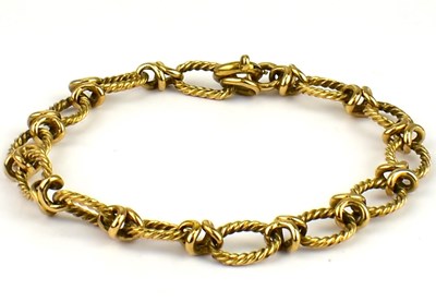 Lot 804 - A 9ct rose gold bracelet with rope twist oval...