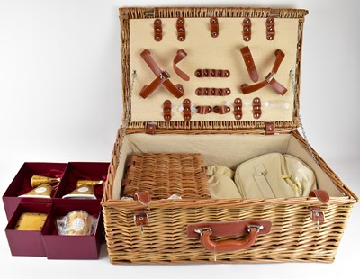 Lot 434 - A modern wicker picnic basket enclosing four...