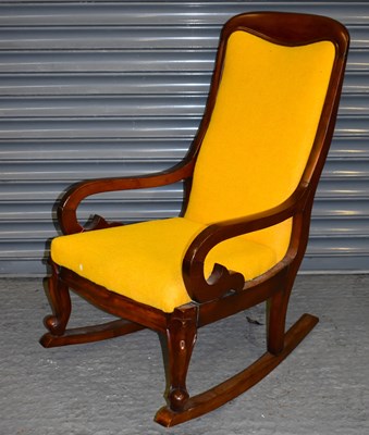 Lot 95 - A Victorian mahogany rocking chair with yellow...