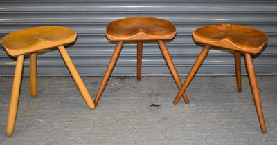 Lot 38 - A set of three mid century saddle seat stools,...